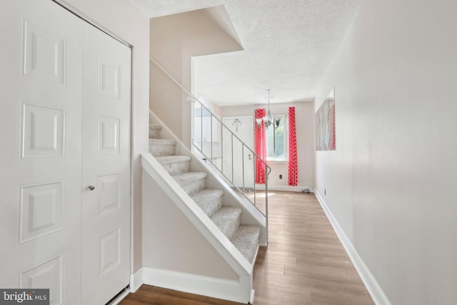 4927 Oxford Ct, Bensalem, PA 19020 - stairway with baseboards, a textured ceiling, and wood finished floors
