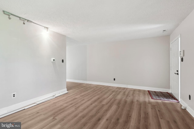 4927 Oxford Ct, Bensalem, PA 19020 - interior space with baseboards, a textured ceiling, track lighting, and wood finished floors