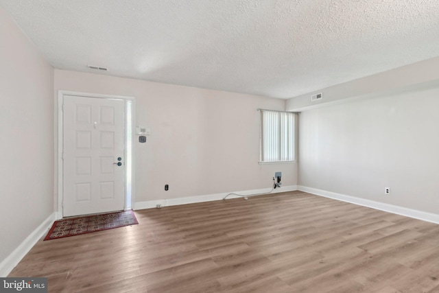 4927 Oxford Ct, Bensalem, PA 19020 - entryway featuring visible vents, a textured ceiling, light wood finished floors, and baseboards