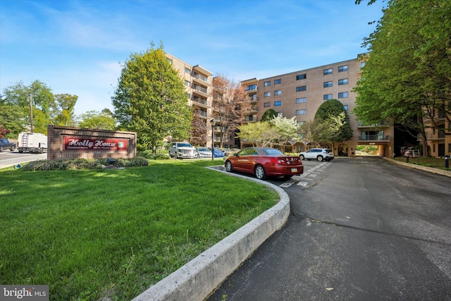 view of building exterior with uncovered parking