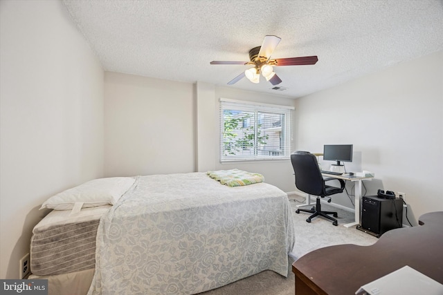 carpeted bedroom with baseboards, a ceiling fan, a textured ceiling, and visible vents