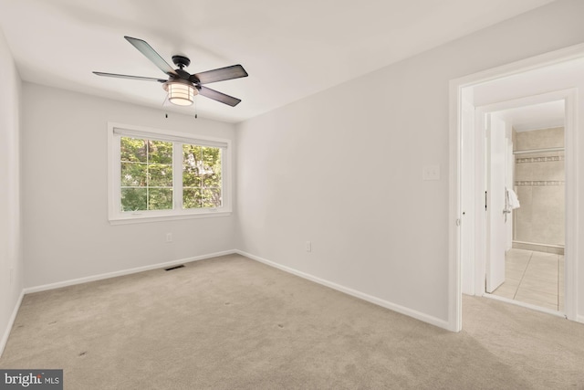 unfurnished bedroom featuring baseboards, carpet flooring, and a ceiling fan
