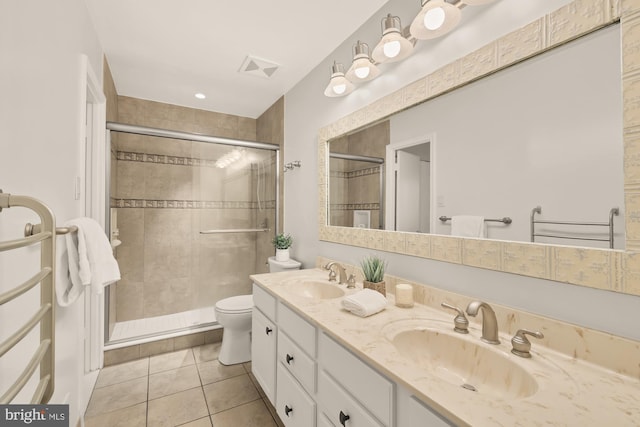full bathroom with a sink, a stall shower, toilet, and double vanity
