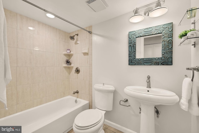 full bathroom with visible vents, tile patterned flooring, toilet, baseboards, and shower / bath combination