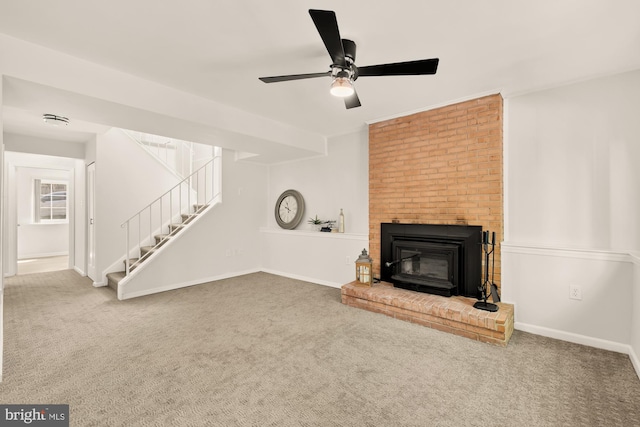 unfurnished living room with baseboards, ceiling fan, carpet, and stairs