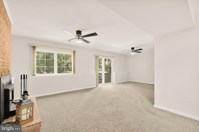 unfurnished living room with baseboards, a ceiling fan, and carpet flooring
