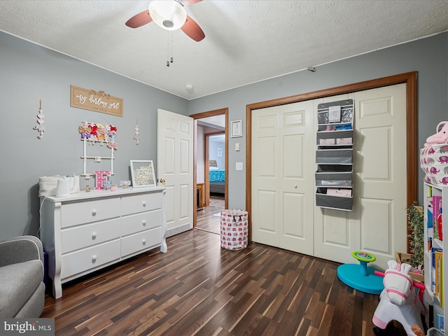 125 Ender Dr, Moorefield, WV 26836 - bedroom with dark wood-type flooring, a textured ceiling, a closet, and a ceiling fan