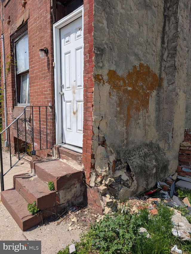 entrance to property with brick siding
