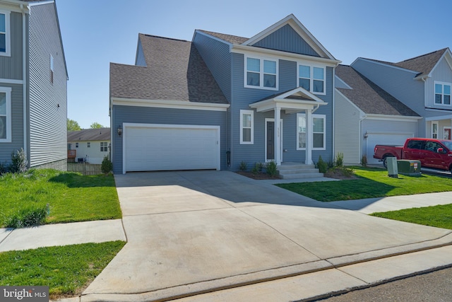 view of front facade featuring an attached garage, a front lawn, board and batten siding, and concrete driveway
