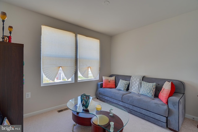 living area featuring baseboards, carpet flooring, and visible vents