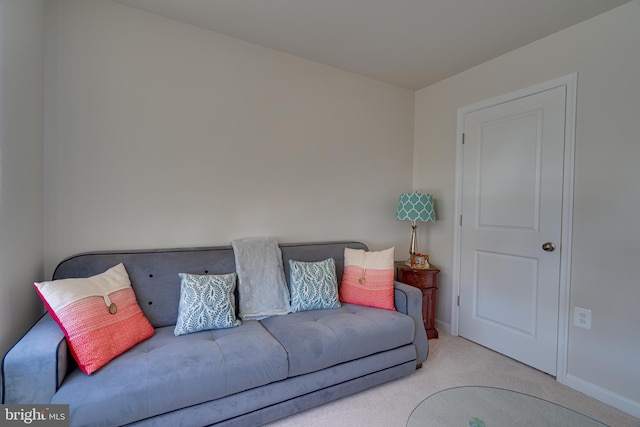 carpeted living room with baseboards