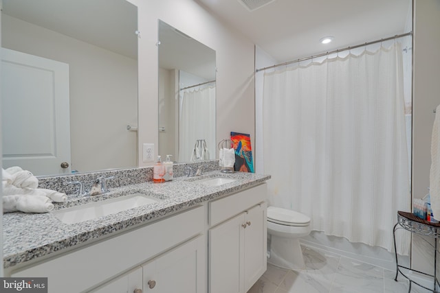 bathroom featuring a sink, toilet, double vanity, and marble finish floor