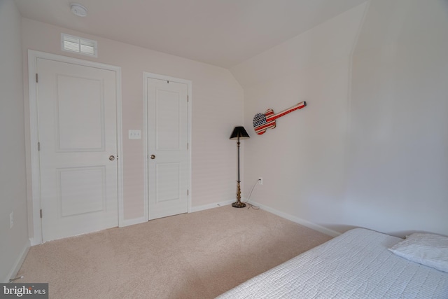 carpeted bedroom with baseboards and visible vents