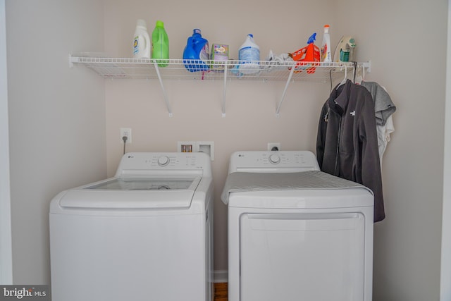 washroom featuring laundry area and washing machine and dryer