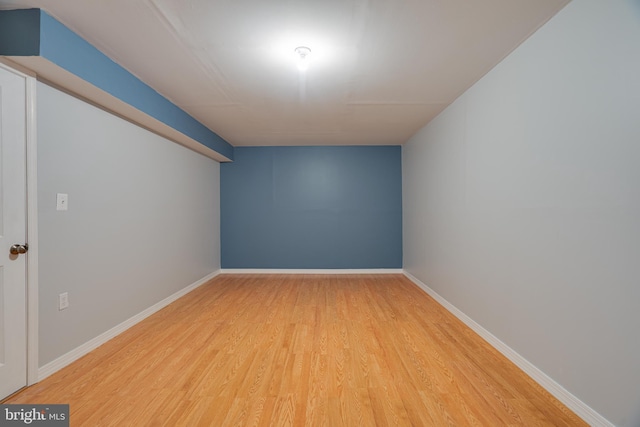 bonus room featuring baseboards and wood finished floors