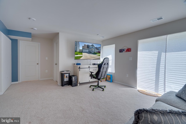 carpeted office with baseboards and visible vents