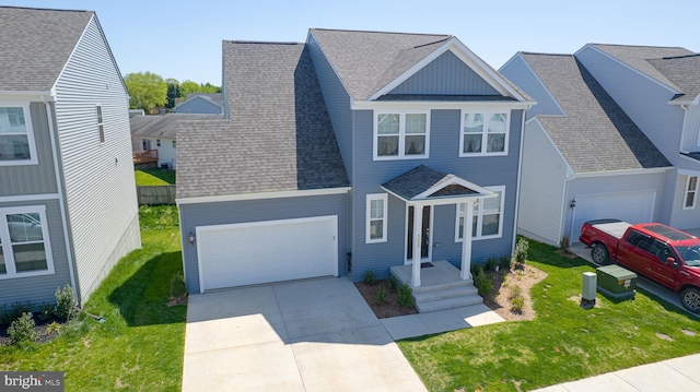 traditional home featuring roof with shingles, concrete driveway, and a front yard