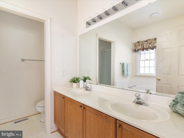 full bath with a sink, toilet, double vanity, and visible vents