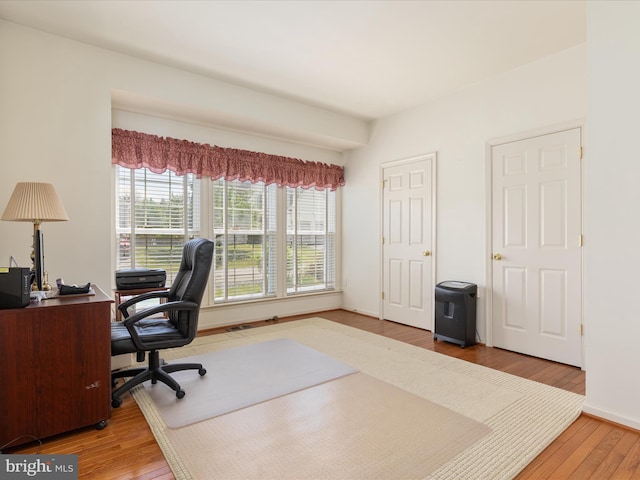 office space with baseboards and wood finished floors
