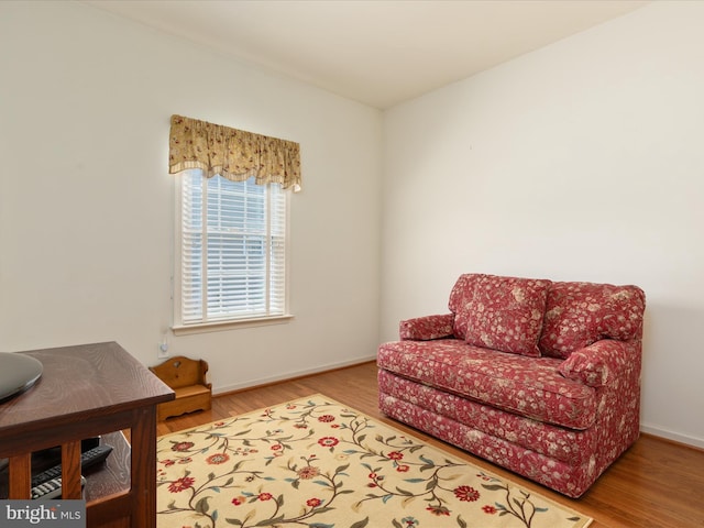living area featuring baseboards and wood finished floors