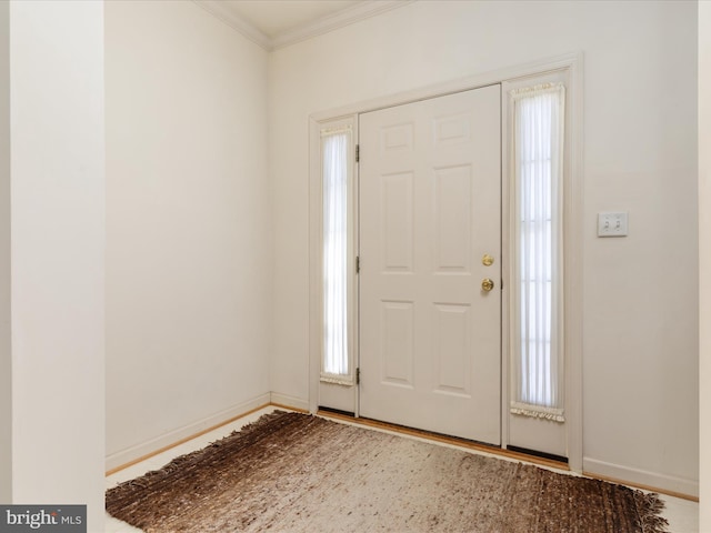 entryway featuring baseboards, ornamental molding, and wood finished floors