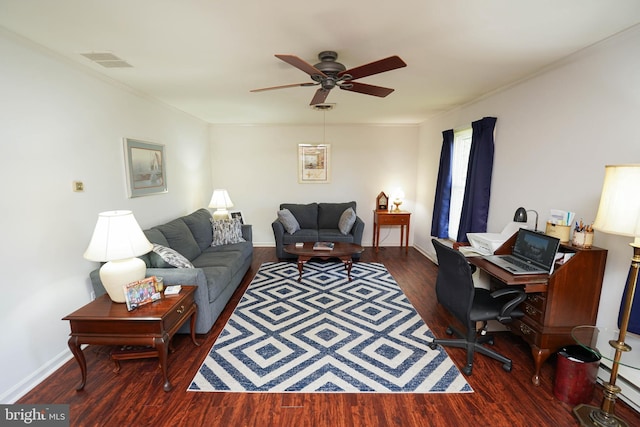 living area with ceiling fan, baseboards, wood finished floors, visible vents, and ornamental molding