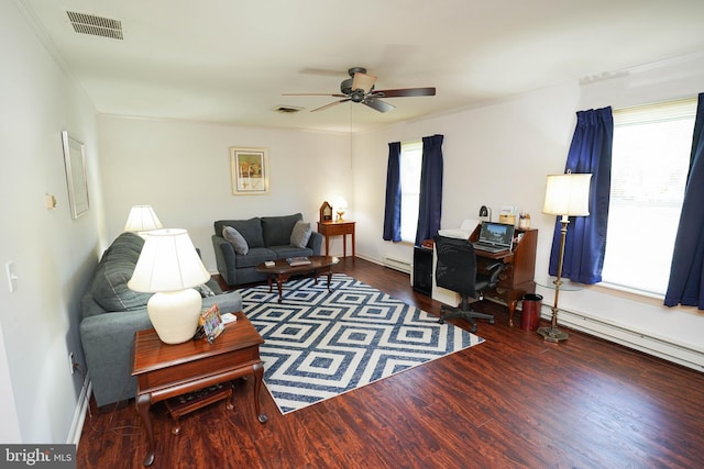 living area featuring visible vents, a baseboard radiator, wood finished floors, and a healthy amount of sunlight