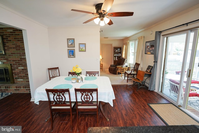 dining space with ceiling fan, ornamental molding, and wood finished floors