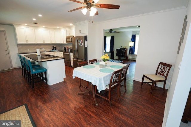 dining area with crown molding, ceiling fan, recessed lighting, and dark wood-type flooring