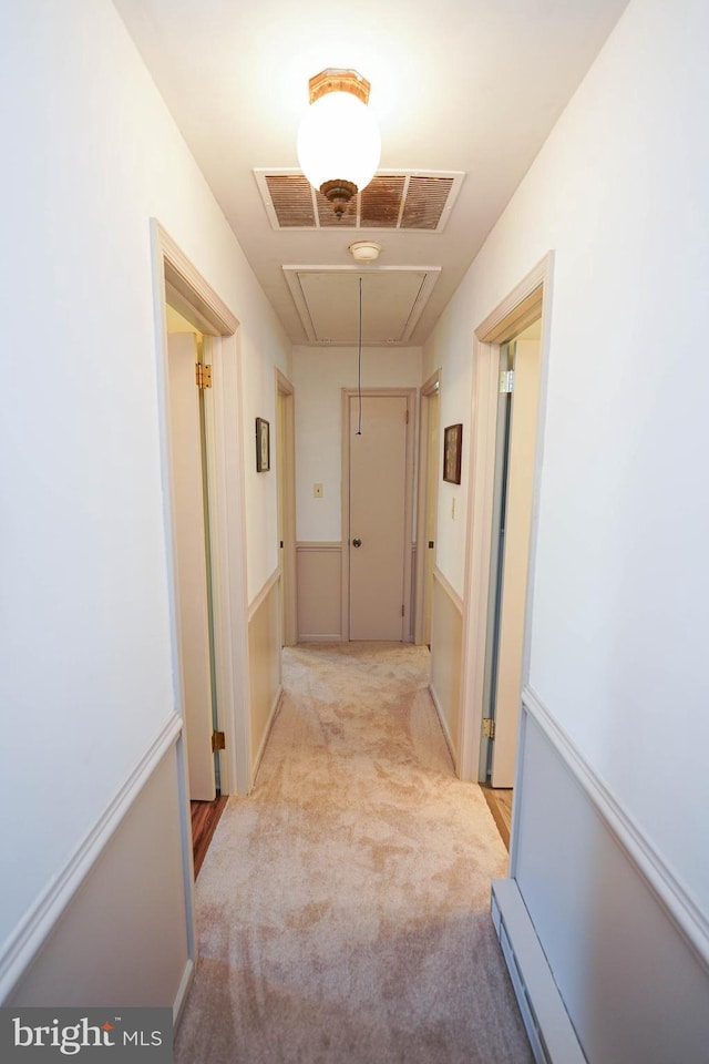 corridor featuring carpet, attic access, and visible vents