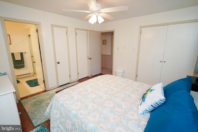 bedroom with ceiling fan, a baseboard radiator, ensuite bath, and wood finished floors