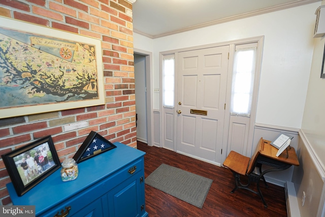 entrance foyer with dark wood-type flooring and ornamental molding