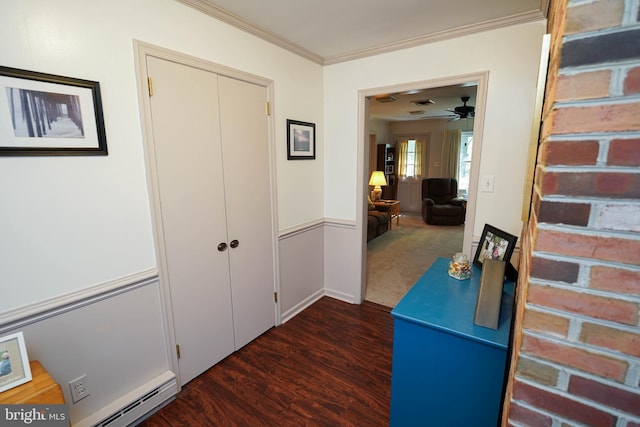 corridor featuring a baseboard heating unit, dark wood finished floors, and ornamental molding