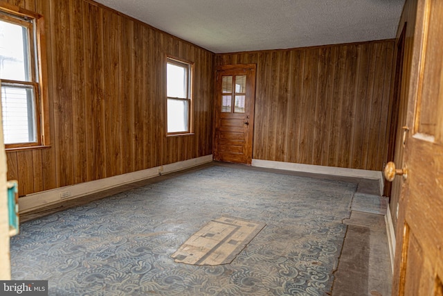 4398 S Bowers Rd, Milford, DE 19963 - carpeted empty room featuring wood walls and a textured ceiling
