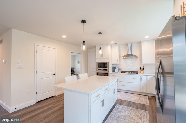 131 Chinaberry Way, Kunkletown, PA 18058 - kitchen with white cabinetry, light countertops, dark wood-style floors, stainless steel appliances, and wall chimney exhaust hood