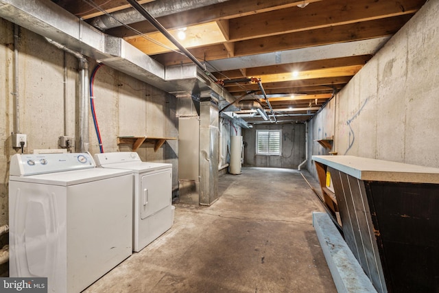 basement with washing machine and clothes dryer and gas water heater