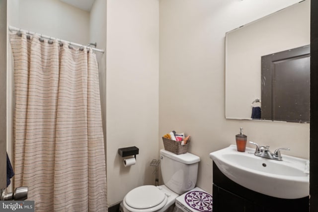 bathroom featuring vanity, toilet, and a shower with shower curtain