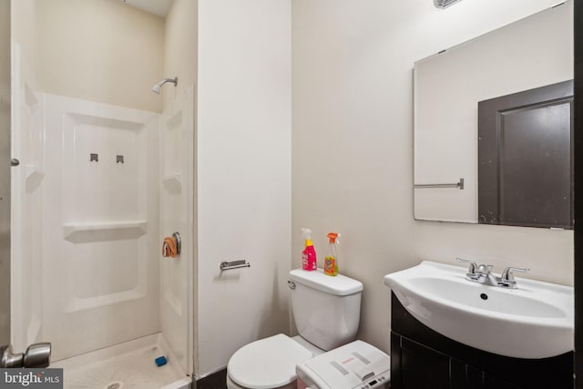 bathroom with vanity, toilet, and a stall shower