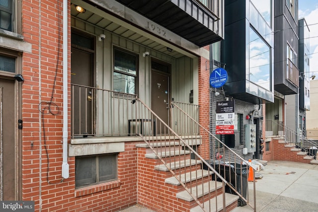 entrance to property with brick siding