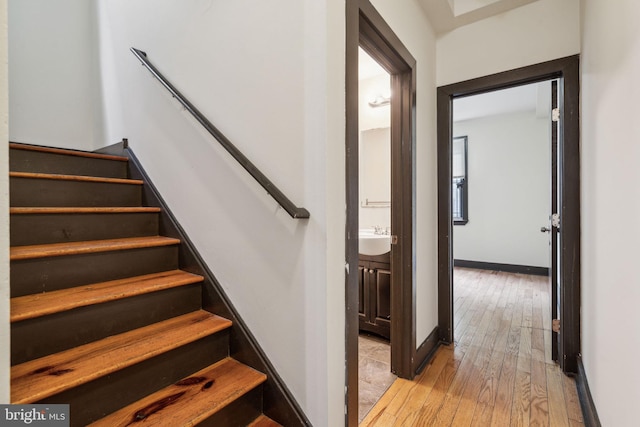 stairs featuring baseboards and wood-type flooring