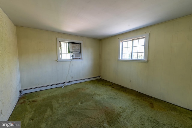 carpeted spare room with a healthy amount of sunlight and a baseboard radiator