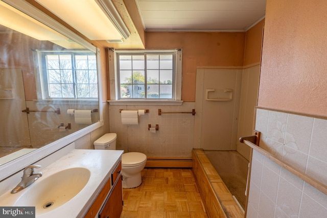 full bathroom featuring vanity, toilet, tile walls, a baseboard heating unit, and a tub to relax in