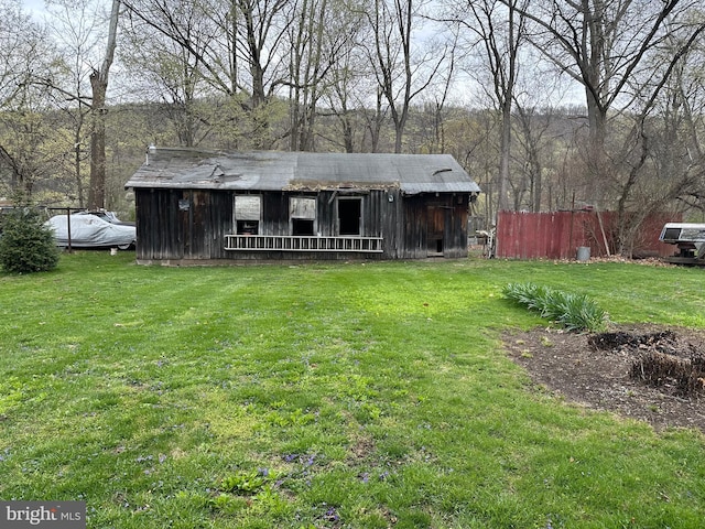 exterior space featuring board and batten siding and a front yard