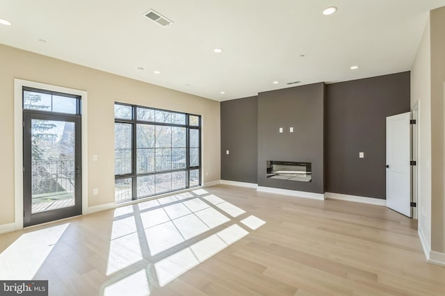 208 Kalos St, Philadelphia, PA 19128 - interior space with light wood finished floors, a glass covered fireplace, recessed lighting, baseboards, and visible vents