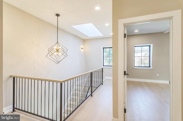 208 Kalos St, Philadelphia, PA 19128 - hall with baseboards, recessed lighting, a skylight, light wood finished floors, and an upstairs landing