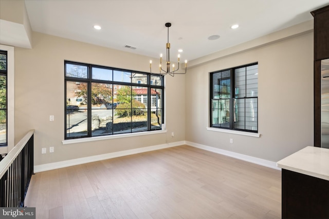 208 Kalos St, Philadelphia, PA 19128 - unfurnished dining area with light wood-style floors, baseboards, recessed lighting, and a notable chandelier