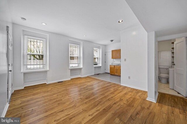 3800 Spring Garden St, Philadelphia, PA 19104 - unfurnished living room with a healthy amount of sunlight, baseboards, and light wood finished floors
