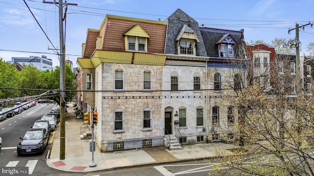 3800 Spring Garden St, Philadelphia, PA 19104 - view of front of property with stone siding, mansard roof, entry steps, and roof with shingles
