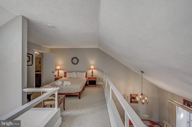 116 Snow Ridge Cir, Lake Harmony, PA 18624 - bedroom featuring light carpet, vaulted ceiling, a textured ceiling, and a chandelier