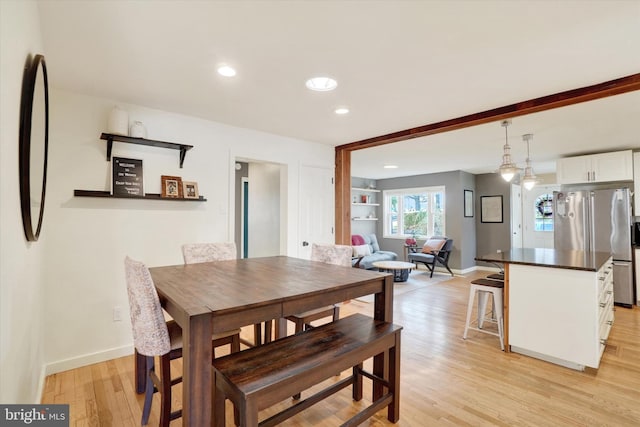 dining area with recessed lighting, light wood-style flooring, and baseboards